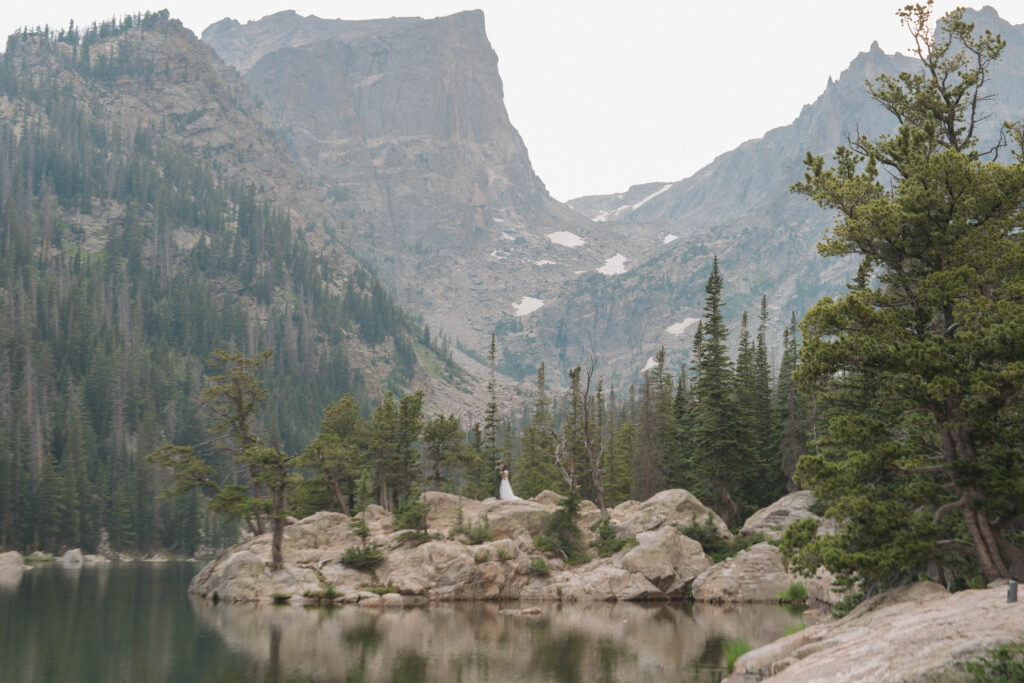Couple embracing at sunset at Dream Lake in Rocky Mountain National Park