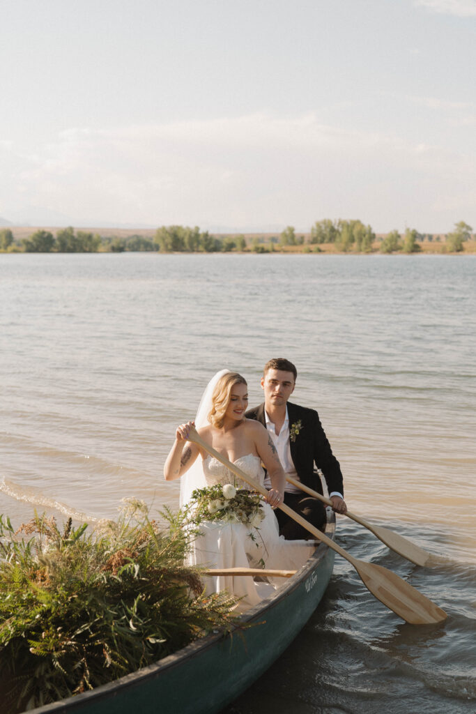 Bride and groom canoeing on a mountain lake after their Colorado elopement