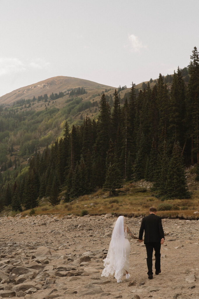 Bride and groom canoeing on a mountain lake after their Colorado elopement